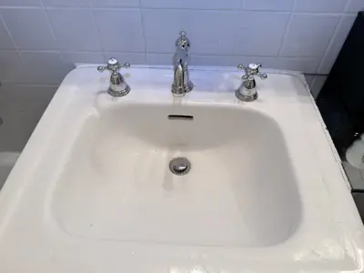 Faucet replacement — old faucet removed, new one installed