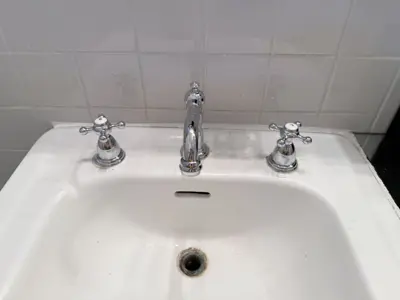Faucet replacement — old faucet removed, new one installed