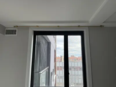 Curtain rod installation in a NYC home