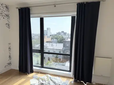 Curtain rod installation in a NYC home