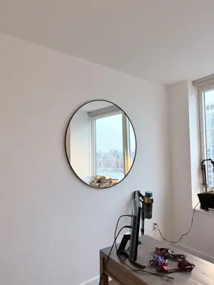 Mirror installation — wall-mounted with secure anchoring