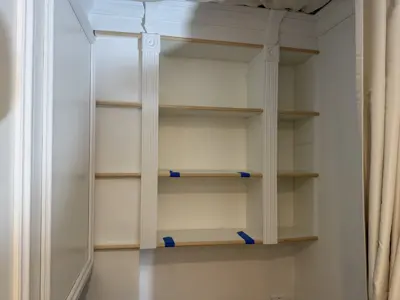 Floating shelf installation on apartment wall