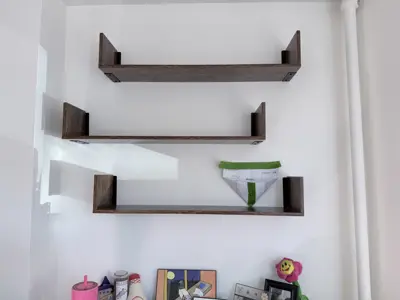 Floating shelf installation on apartment wall