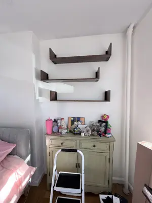 Floating shelf installation on apartment wall