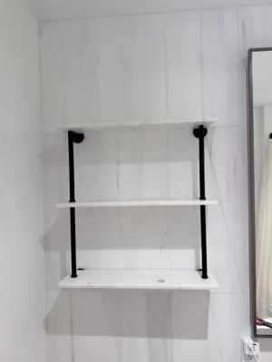 Floating shelf installation on apartment wall