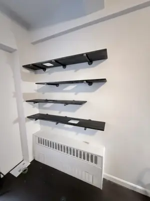 Floating shelf installation on apartment wall