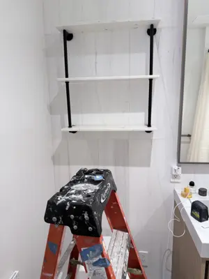 Floating shelf installation on apartment wall