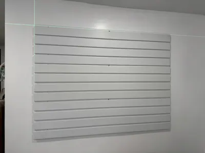 Floating shelf installation on apartment wall