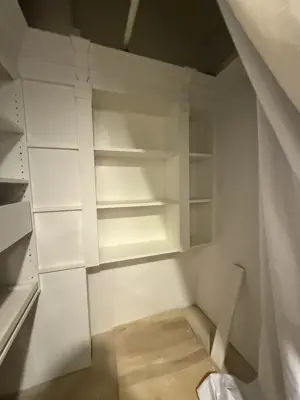 Floating shelf installation on apartment wall