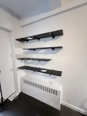 Floating shelf installation on apartment wall