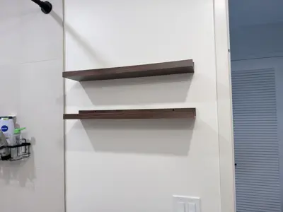 Floating shelf installation on apartment wall