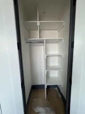 Floating shelf installation on apartment wall