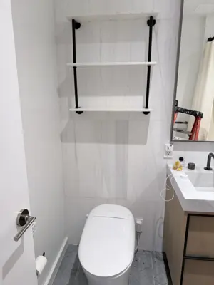 Floating shelf installation on apartment wall