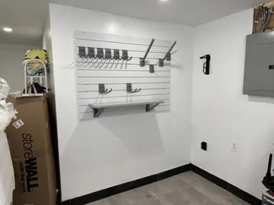 Floating shelf installation on apartment wall