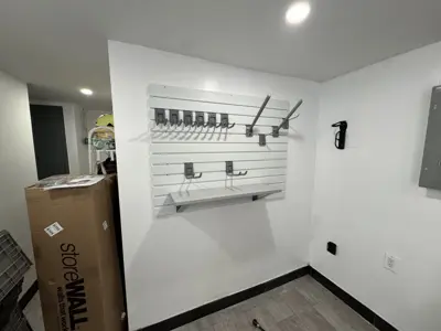 Floating shelf installation on apartment wall