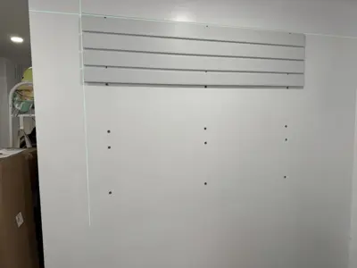 Floating shelf installation on apartment wall