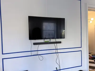 TV wall mounting — flat screen mounted with bracket and cable management