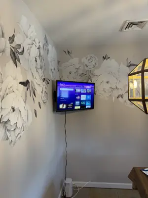 TV wall mounting — flat screen mounted with bracket and cable management