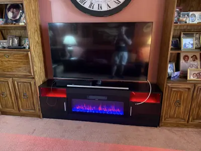 Assembled entertainment center with electric fireplace and mounted TV in NYC living room