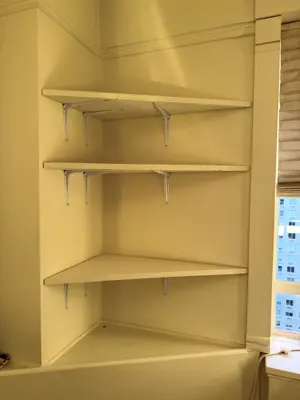 Floating shelf installation on apartment wall
