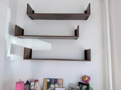 Floating shelf installation on apartment wall