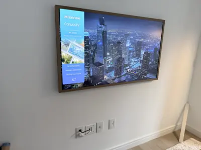 TV wall mounting — flat screen mounted with bracket and cable management